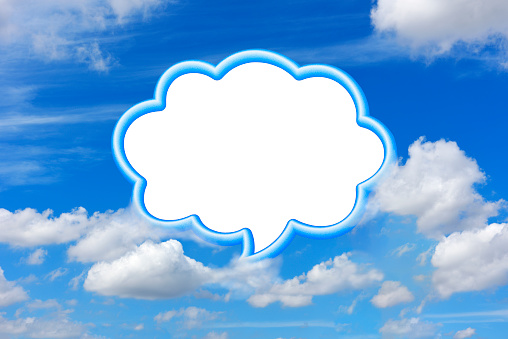 Close-up of blank blue frame speech bubble floating in mid-air against blue sky.