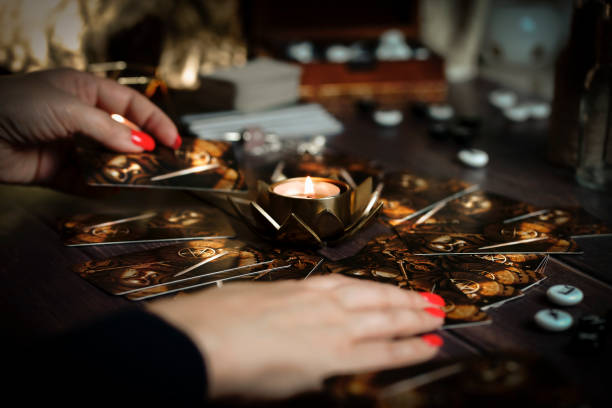 istock Defocused still Life with tarot cards. magic or fortune telling rite with occult and esoteric symbols. 1466245327