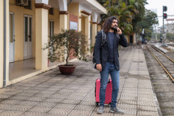 istock Young man at the train station 1466249634