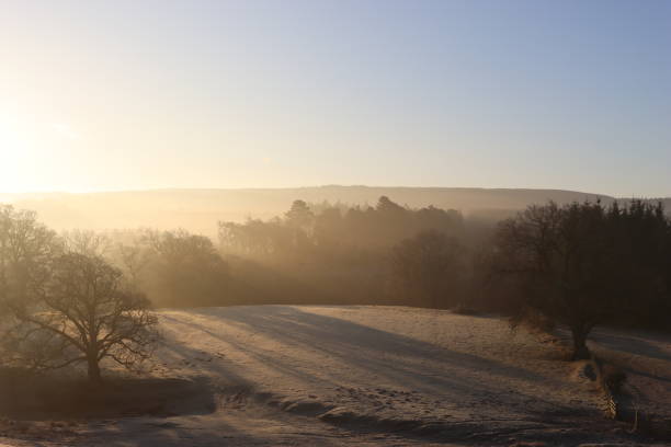 istock Sunrise over a frost covered countryside landscape 1466256332
