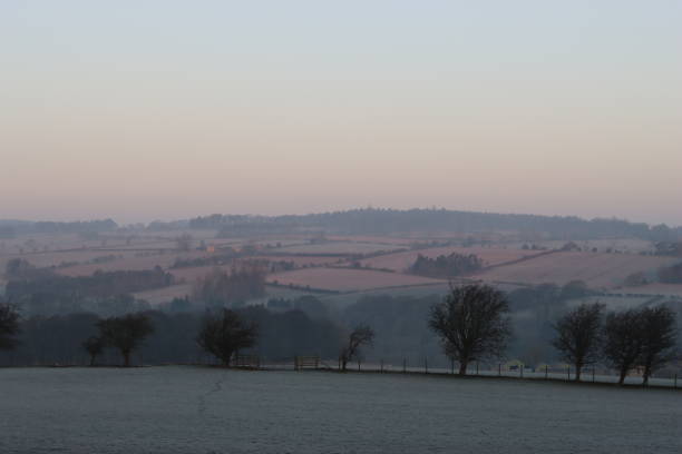 istock View across a frost covered landscape at dawn with pink tinged fields 1466257061