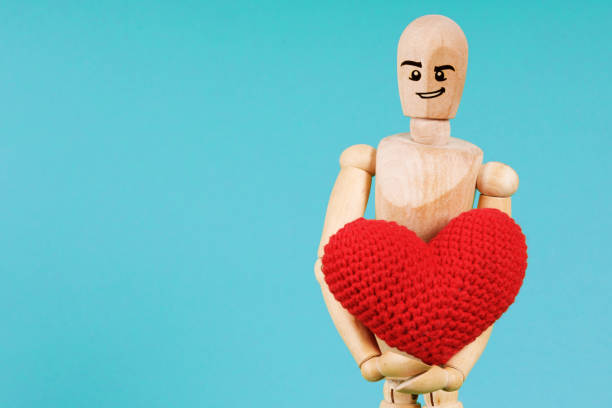 istock wooden man with red heart on blue background 1466258930