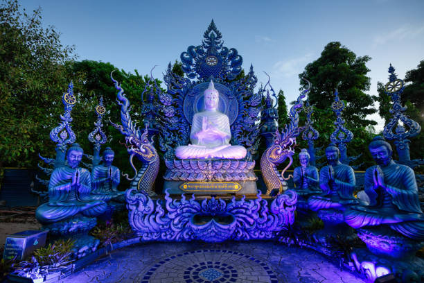 Blue Temple Buddha Statue Wat Rong Suea Ten Chiang Rai Thailand Illuminated Modern White Buddha Statue in the famous Blue Temple Wat Rong Suea Ten Complex in Chiang Rai. Illuminated Buddha under Sunset Twilight. Blue Temple Buddha Statue of the modern Buddhist Wat Rong Suea Ten Temple. Blue Temple - Wat Rong Suea Ten, Chiang Rai, Northern Thailand, Southeast Asia. chiang rai province stock pictures, royalty-free photos & images