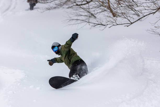 Snowboarder riding the famous powder snow of North Japan A freestyle snowboarder riding in Shizukuishi, Iwate. Famous powder of North Japan. japanese snowboarder stock pictures, royalty-free photos & images