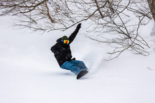 Snowboarder riding the famous powder snow of North Japan A freestyle snowboarder riding in Shizukuishi, Iwate. Famous powder of North Japan. japanese snowboarder stock pictures, royalty-free photos & images