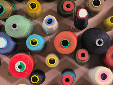 Colorful thread spools in a dressmaker's workshop