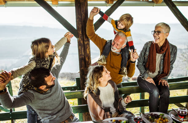 istock Happy multi-generation family having fun during lunch on a balcony. 1466275479