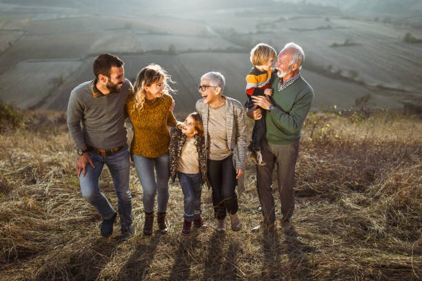 istock Happy multi-generation family talking while taking a walk on the field. 1466275711
