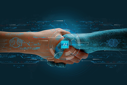 Humans shake hands with AI to show partnership. Machine learning to enable and work together to achieve greater innovation and success.