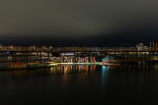 Copenhagen, Denmark Kajaks parked at night on the Kalvebod Brygge in the harbor.