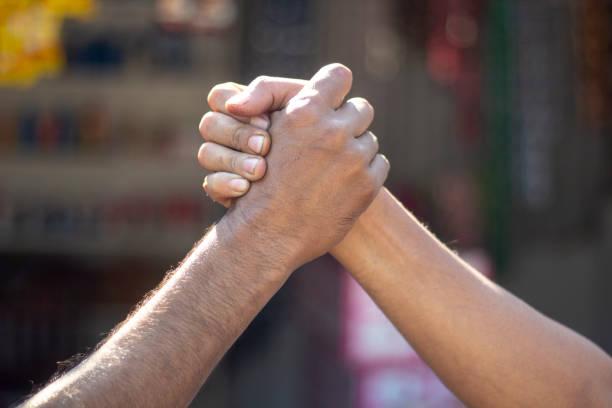 istock there is two man they meet their hands with one another and the background is blurred 1466282180