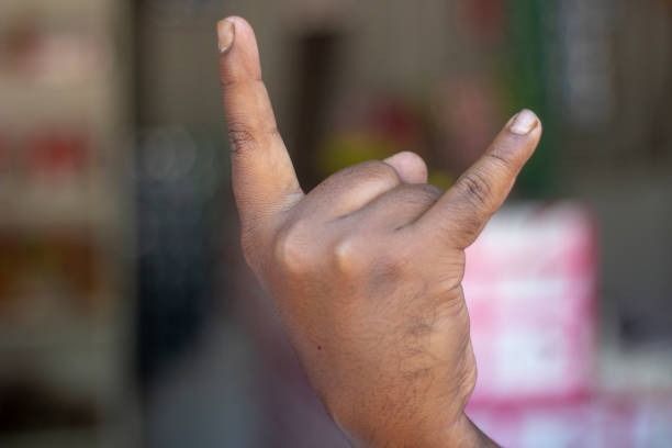a man show his own hand style and the background is blurred