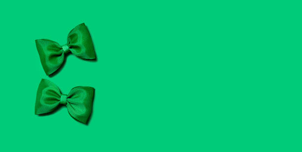istock St. Patrick's Day background. Two green bows on a green background. Banner. Copy space. 1466289780