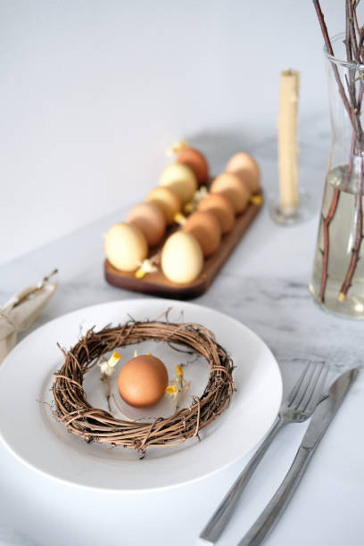 istock Festive Easter table setting with Easter bunny made of linen napkin and yellow egg 1466289886