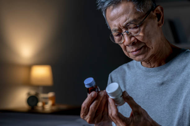 istock Asian senior man taking medication in bed room 1466291449