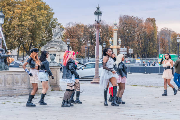 K-pop cover band dancing and shooting a music video in Paris K-pop cover band dancing and shooting a music video on the Place de la Concorde at sunset in Paris, France k pop stock pictures, royalty-free photos & images