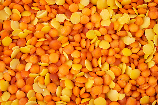 Mix of red and yellow lentils background or texture.