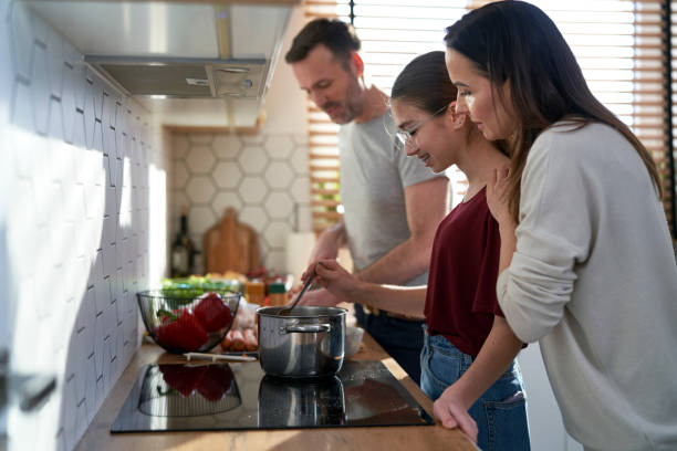 istock Caucasian family cooking dinner together 1466296920