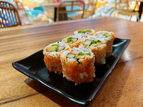 Japanese California sushi roll filled with avocado, crab, and cucumber, it's fresh and crunchy and makes a filling meal.