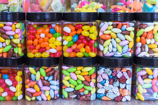 Many colorful candy and lollipops with gum in jars