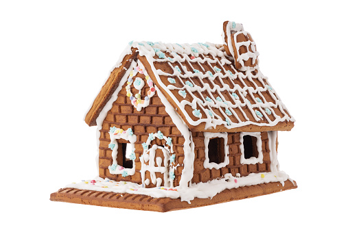 A gingerbread house surrounded by Christmas cookies
