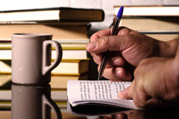 istock A boy who reads and studies, with some books in the background and a cup for drinking 1466301006