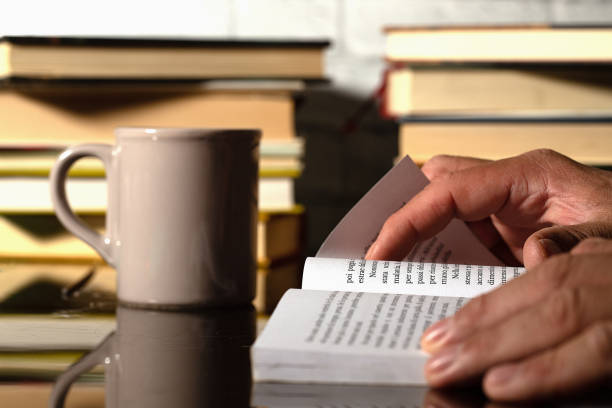 istock A boy who reads and studies, with some books in the background and a cup for drinking 1466301016