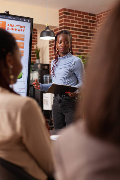 istock Businesswoman explaining company strategy showing financial graph 1466302220