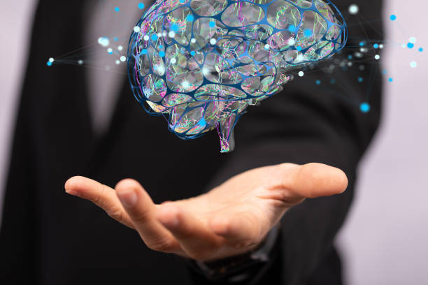 istock Closeup of 3D rendered human brain anatomical model hovering in man’s hand 1466303565