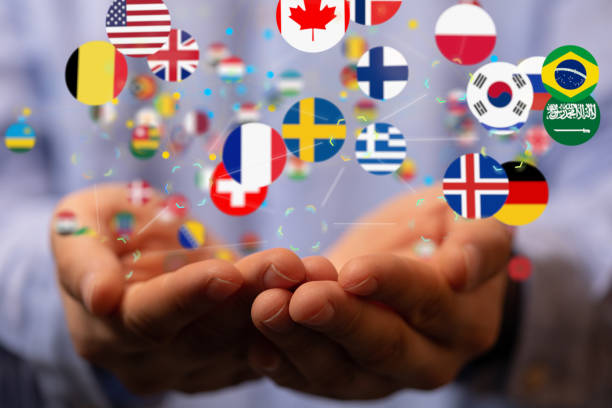 istock 3D modeling of different national flags connected with schemes over human hands 1466303951
