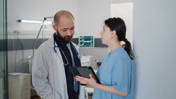 istock Doctor and nurse with tablet talking about treatment for patient 1466304113