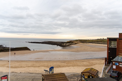 Cullercoats, United Kingdom – February 10, 2023: Scenic view of Cullercoats Bay beach in the village of Cullercoats, near Tynemouth, UK, by the sea.