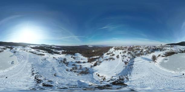 istock High-angle of winter landscape view with deciduous trees on snowy mountains, clear sky background 1466304717
