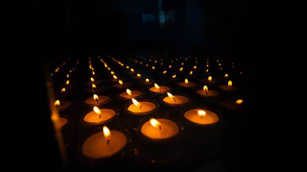 istock Burning candles on a black background. 1466305128