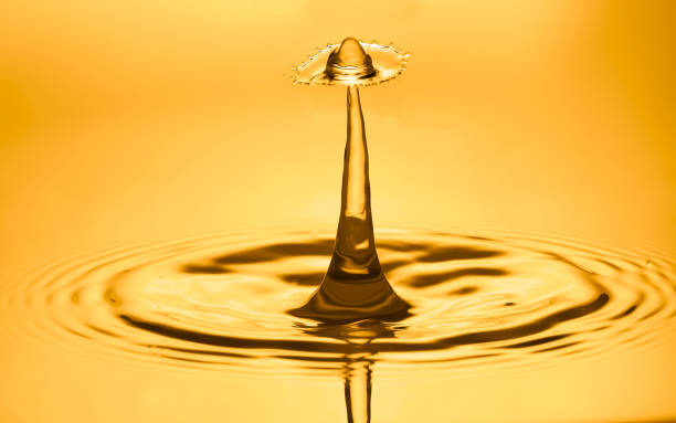 istock Golden water splash and droplets background. 1466306477