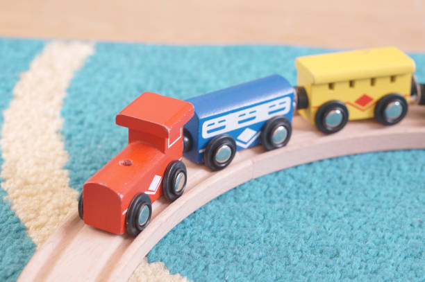istock Wooden train toy on a blue carpet 1466308149