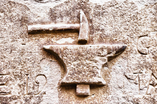 istock Closeup shot of blacksmith tools engraved on a concrete surface 1466308732