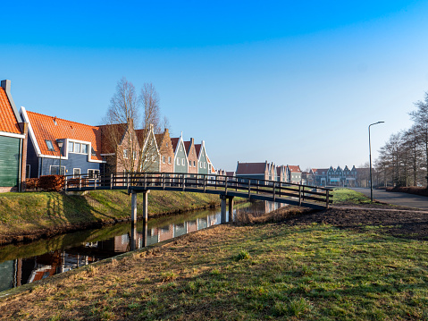 A traditional Dutch village with colorful, old wooden houses, and canals