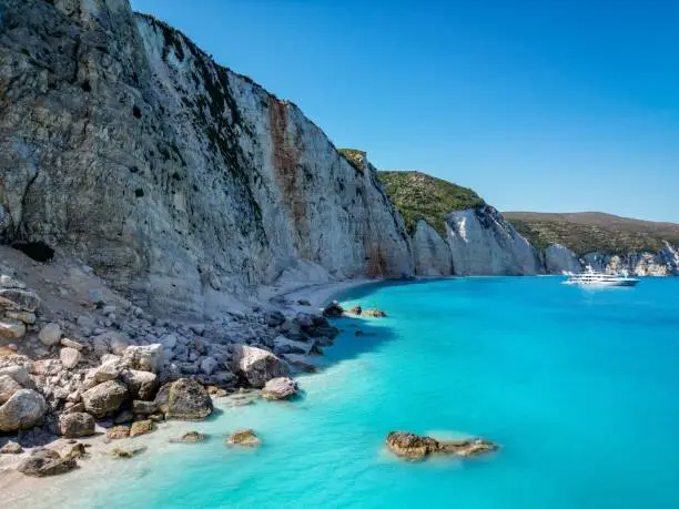 Photo of (4K) Drone shot of the Limestone hillside at Fteri Beach, Kefalonia, Cephalonia, Greece