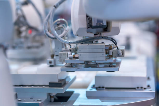 istock Closeup of robotic arms assembling a smartphone at a modern factory 1466311507