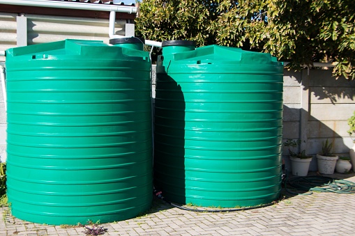 Water saving rain water catchment plastic tanks setup backyard pipes