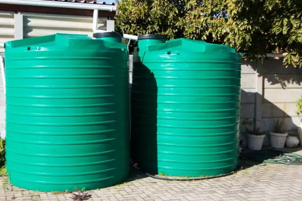 Photo of Water saving rain water catchment plastic tanks setup backyard pipes