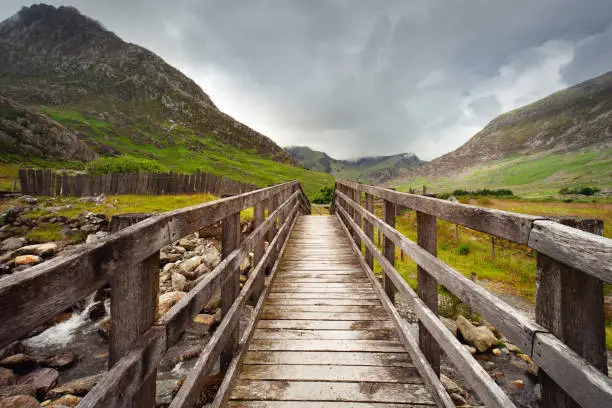 A wooden bridge over a mountain stream in front of Tryfan between gwern gof isaf and Llyn Ogwen