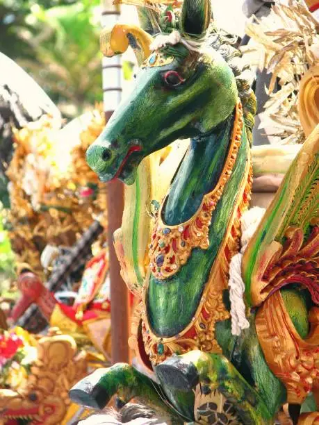 Photo of Close up wooden statue of winged green horse in ritual event parade in Bali, Indonesia.