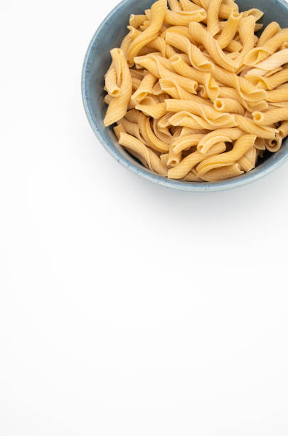 Bowl of cooked pasta on a wh background with copy space at the bottom