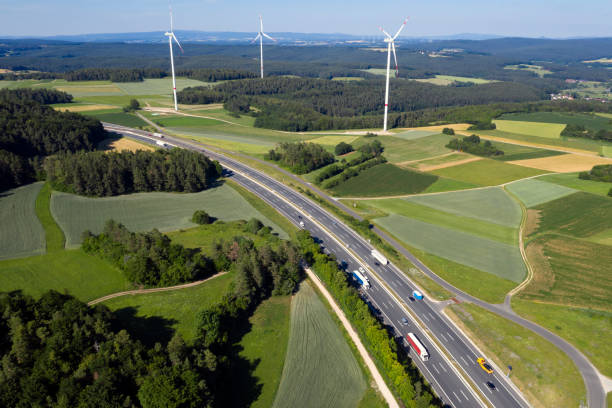 istock Rural highway and wind turbines aerial view 1466316233