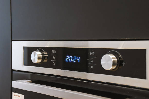 istock Closeup of controls from a modern stainless steel oven with timer 1466318845