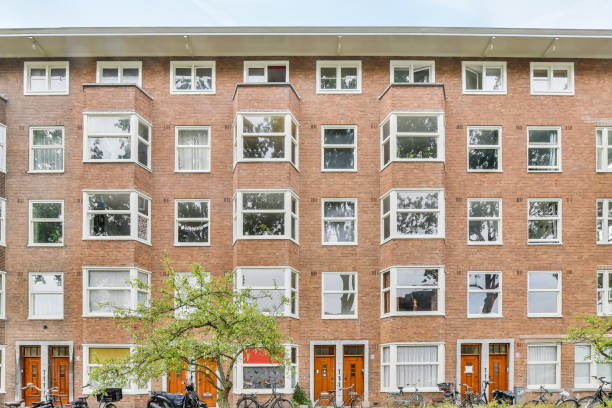 istock Brick building facade with trees and bicycles 1466318875