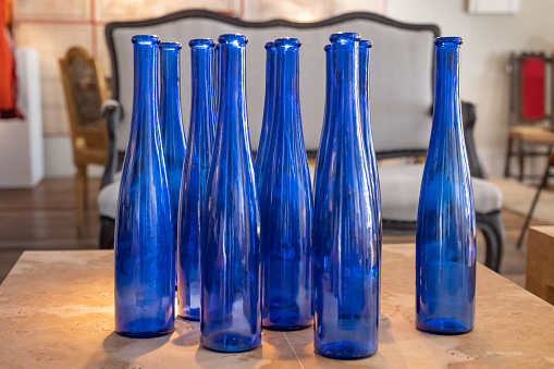 Glass bottles as decoration in foreground with out of focus background