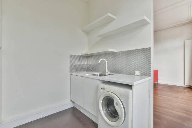 istock Washing machine in a white room 1466320804